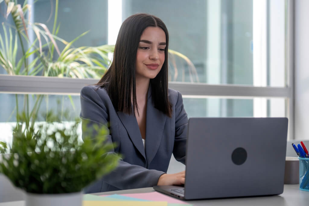 Woman working on laptop analyzing marketing data