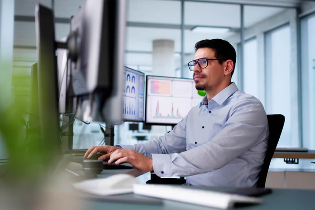 Man working on laptop analyzing marketing data