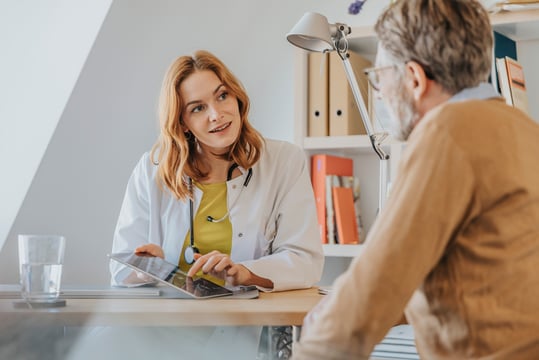 Website Featured Image_PNG-3493_Doctor with digital tablet talking to patient