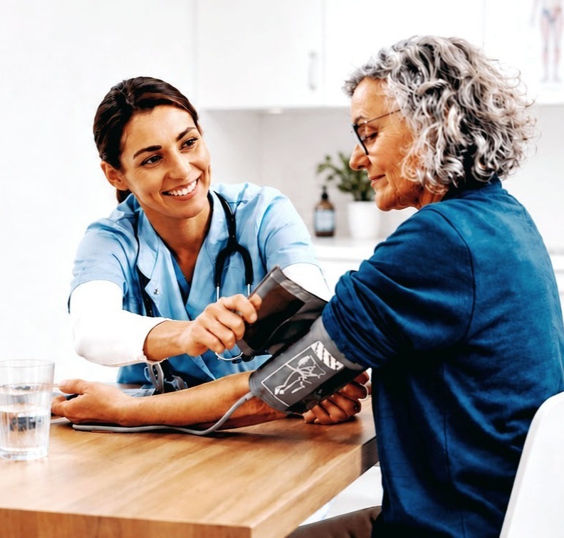 Nurse practitioner taking blood pressure of patient
