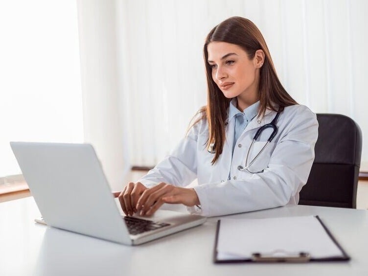 Website Featured_JPG-3448_Doctor typing report on laptop-1